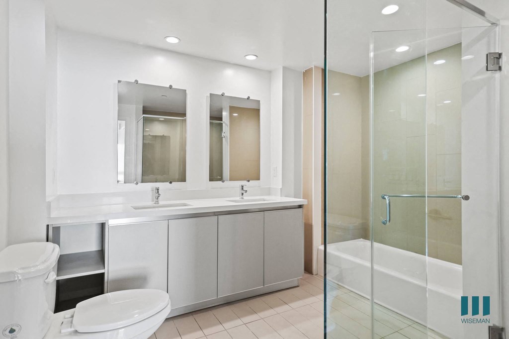Bathroom with Walk-In Shower, Bathtub, and Double-Sink Vanity with Cabinet Storage