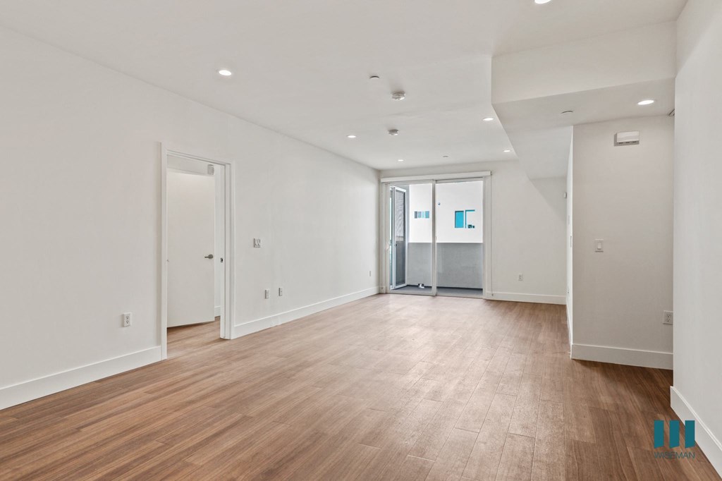 Open-Concept Dining and Living Room with Vinyl Flooring, Recessed Lighting, and Patio