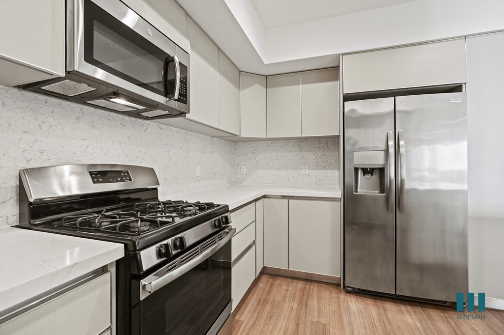 Kitchen with Stainless-Steel Refrigerator, Stove, and Microwave Oven