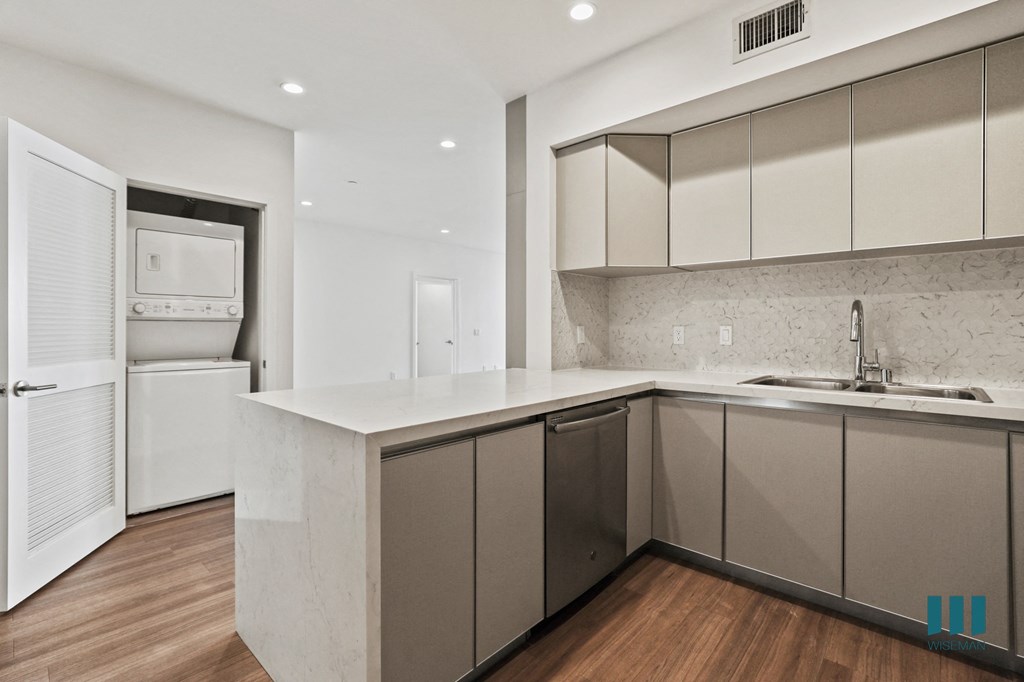 Kitchen with Countertop Bar and In-Suite Washer & Dryer