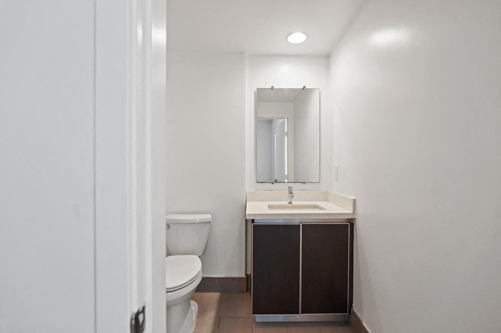 a bathroom with a toilet sink and mirror