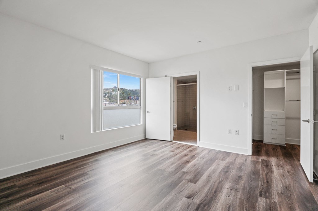 Bedroom with Walk-In Closet, Bathroom, and Large Windows