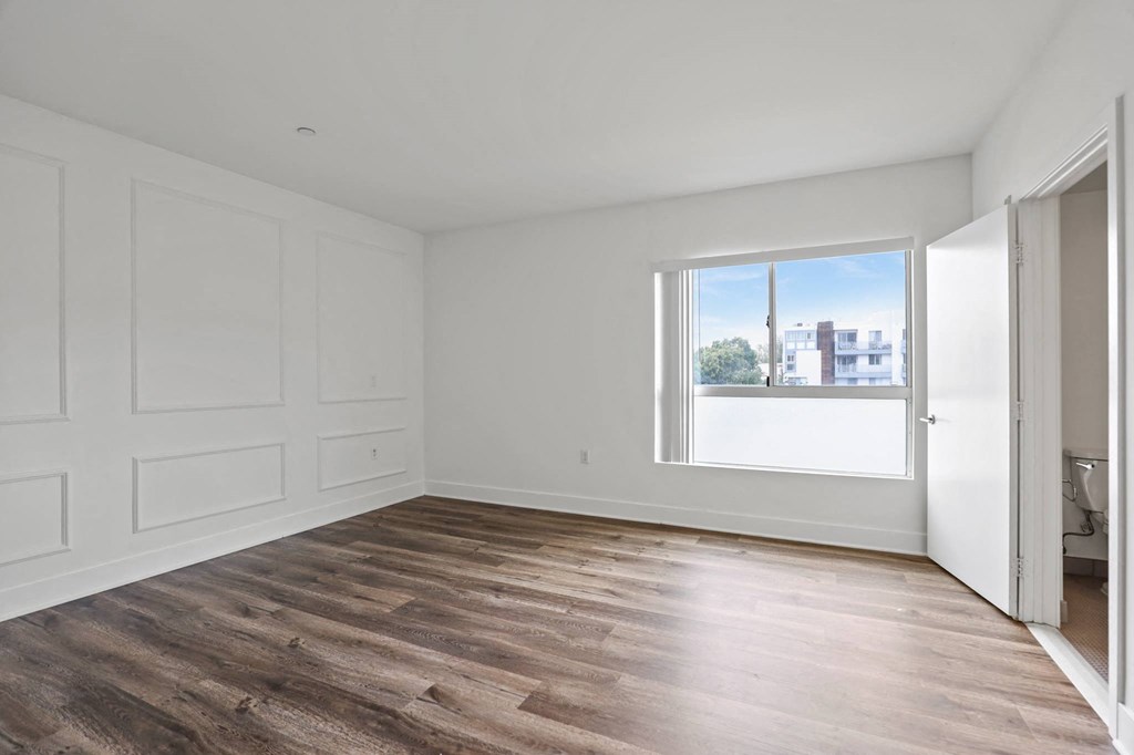 Large-Size Bedroom with Bathroom, Vinyl Flooring, and Windows
