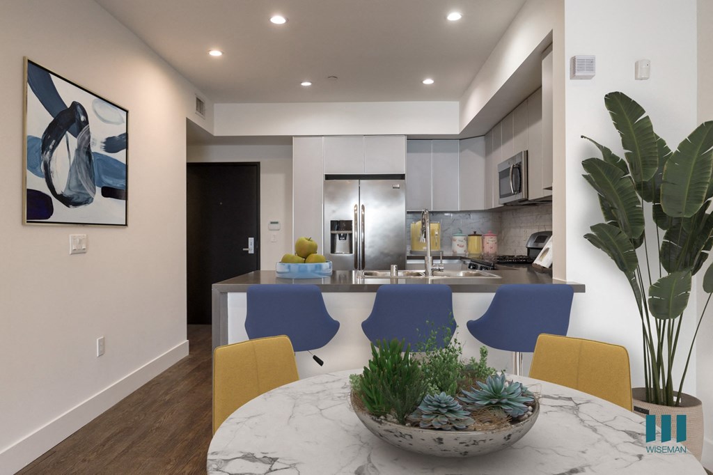 Open-Concept Kitchen with Stainless-Steel Appliances and Countertop Bar