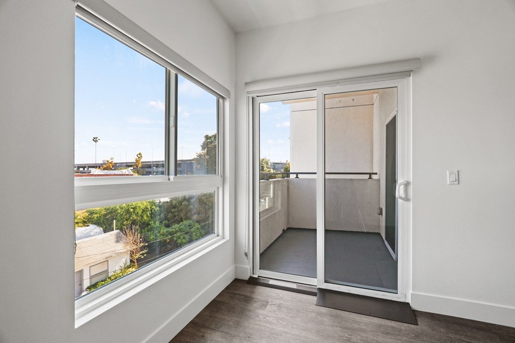 Living Room with Vinyl Flooring, Large-Size Windows, and Patio