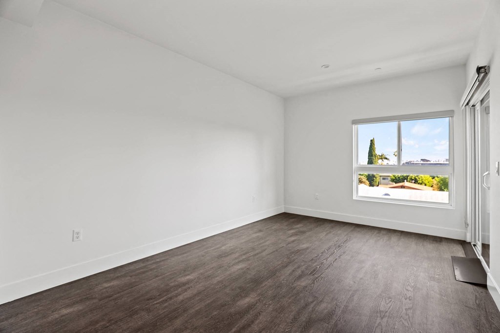 Living Room with Large Windows, Vinyl Flooring, and Patio