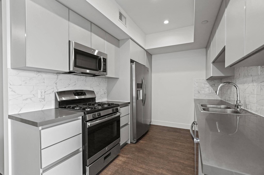 Kitchen with Stainless Steel Stove, Microwave Oven, and Refrigerator