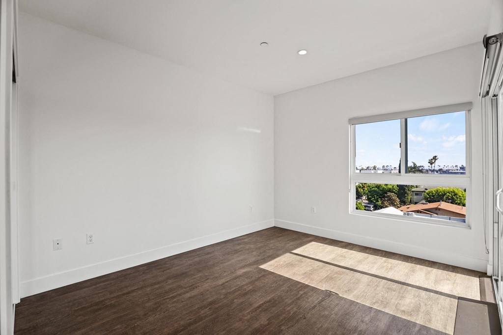 Bedroom with Large-Size Windows, Patio, and Vinyl Flooring
