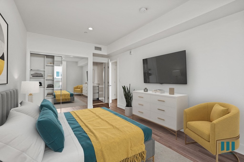 Bedroom with Mirrored Closet with Shelving, Bathroom, and Vinyl Flooring