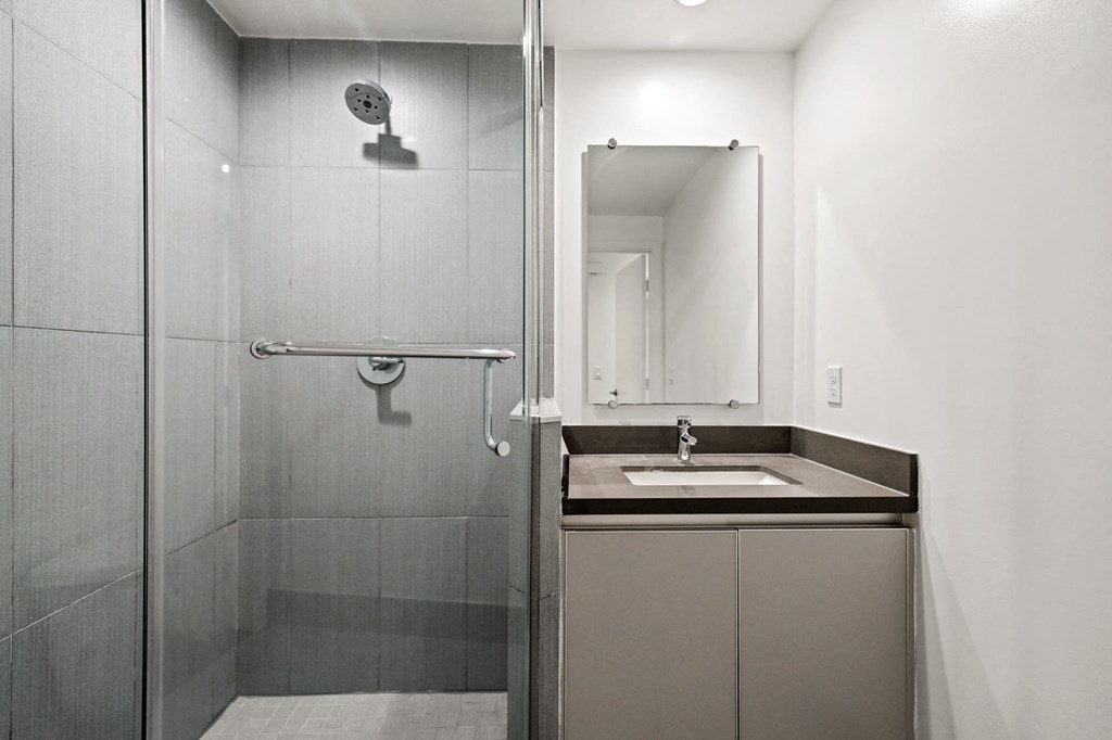 Bathroom with a Stand-Up Shower with Glass Door and Cabinet Storage