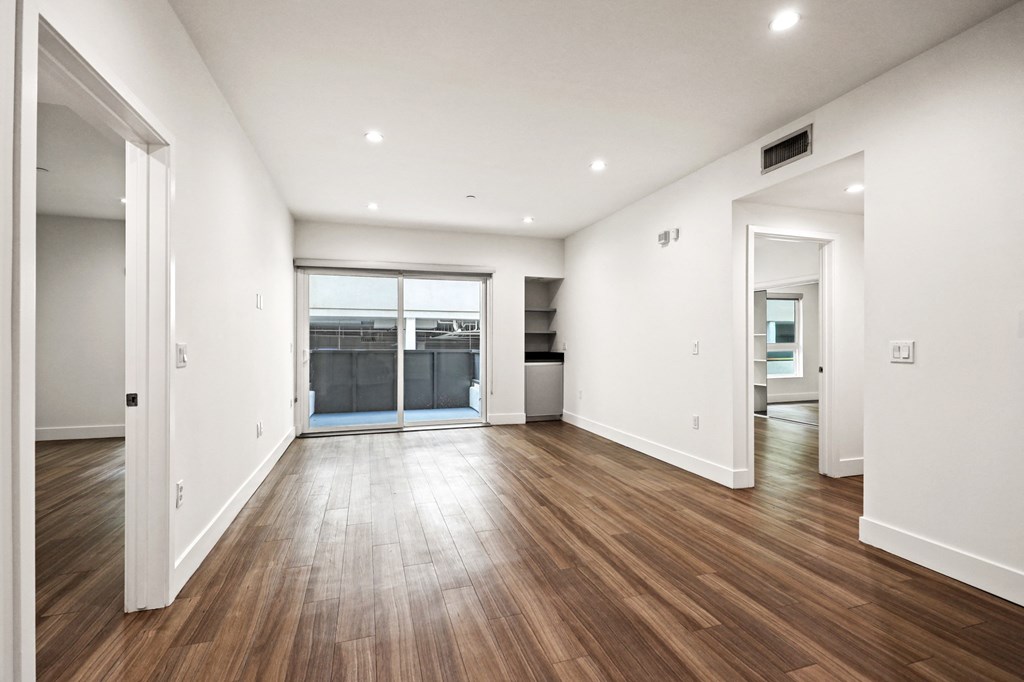 Living Room with Built-In Storage, Patio, and Vinyl Flooring