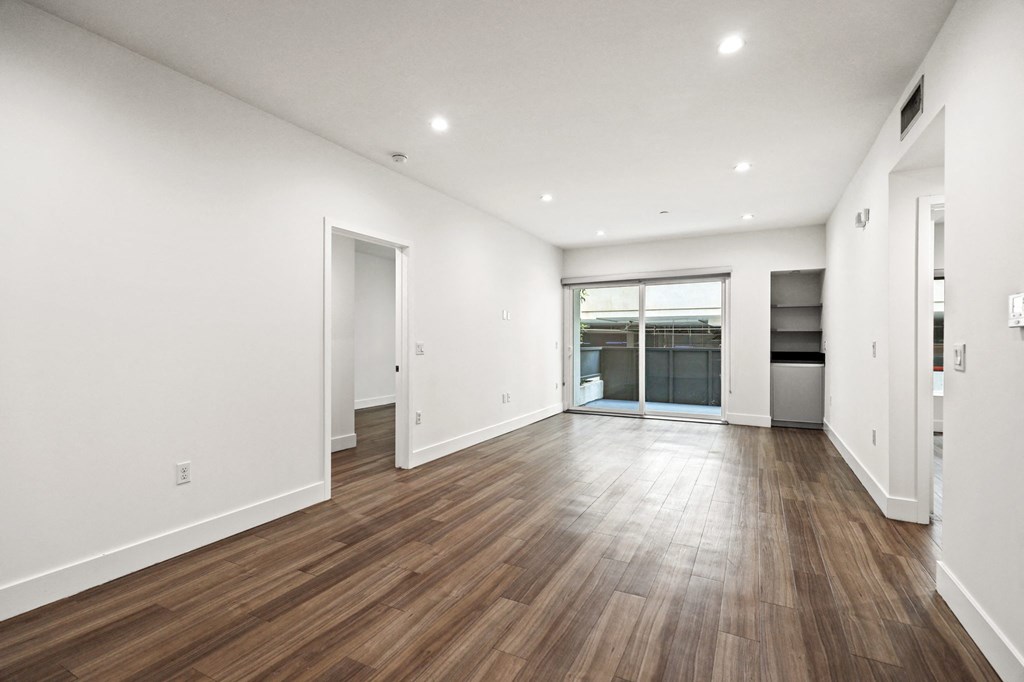Living Room with Built-In Storage, Patio, and Vinyl Flooring