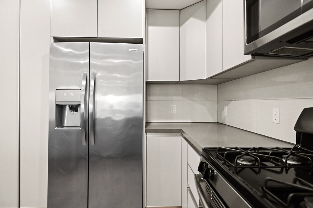 Kitchen with Stainless-Steel Refrigerator, Stove, and Microwave Oven