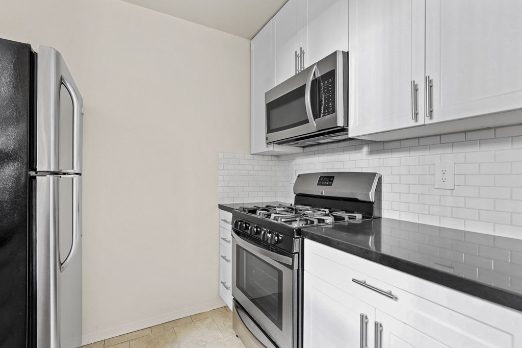 Kitchen with Stainless-Steel Refrigerator, Stove, and Microwave Oven