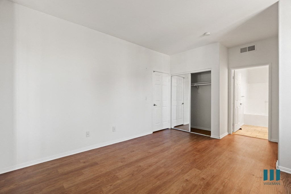 Bedroom with Bathroom, Closet, and Vinyl Flooring