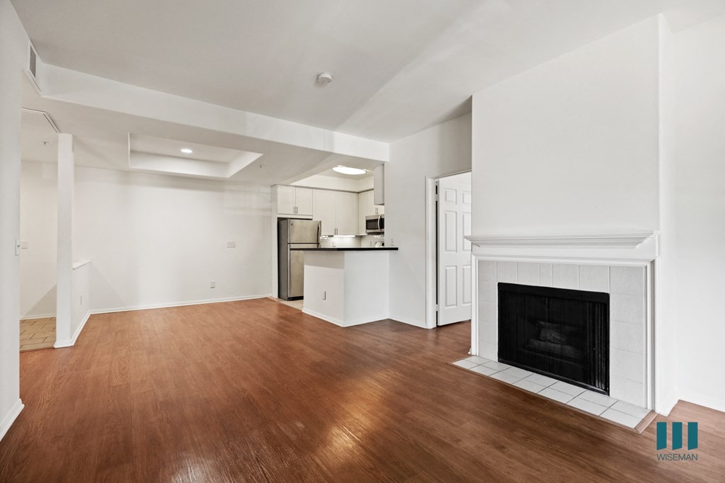 Open-Concept Kitchen, Dining, and Living Room with an Electric Fireplace