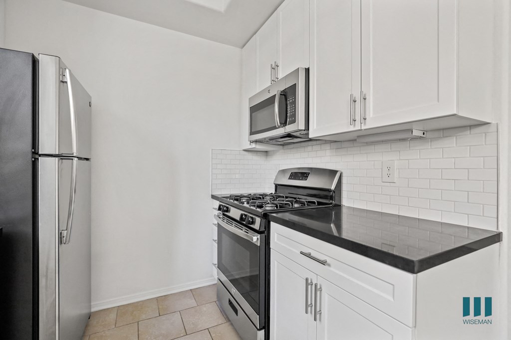Kitchen with Stainless-Steel Refrigerator, Stove, and Microwave Oven