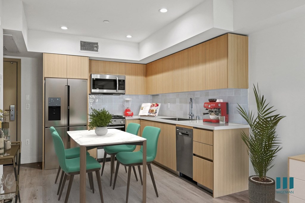 A kitchen with a table and chairs.