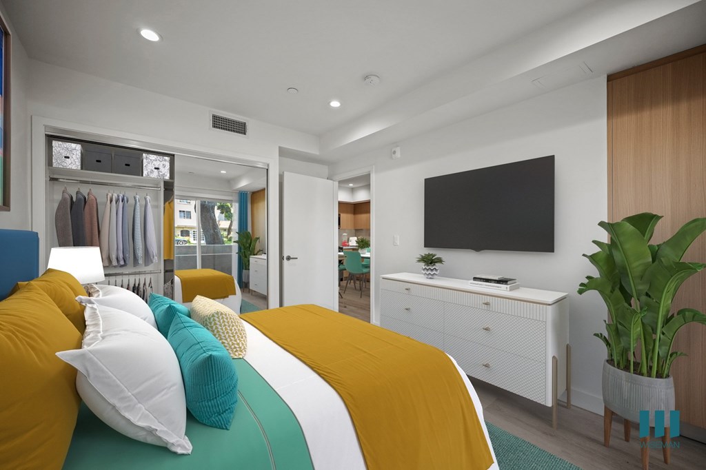 A bedroom with a bed, a TV, and a wardrobe.