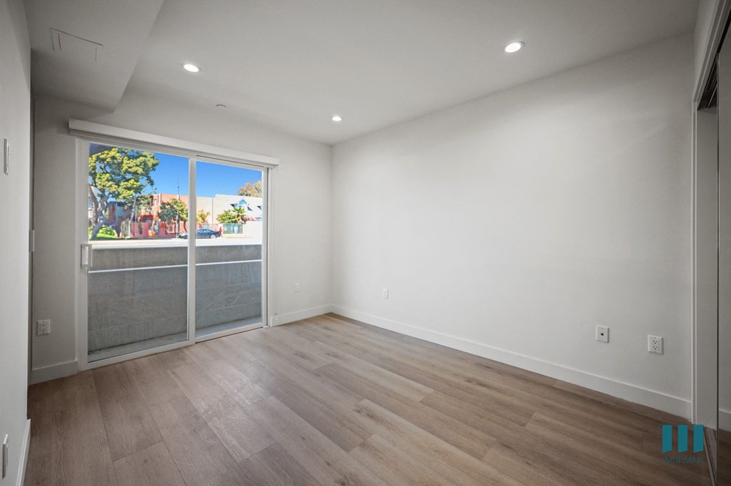 A room with a window overlooking a street.
