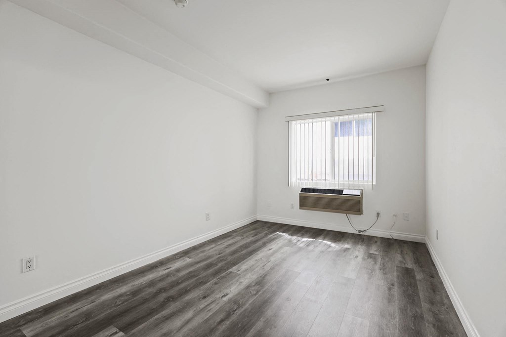 Bedroom with Vinyl Flooring, AC Unit, and Large Window