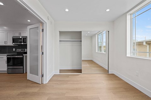Bedroom with Mirrored Closet, Recessed Lighting, and Double Windows