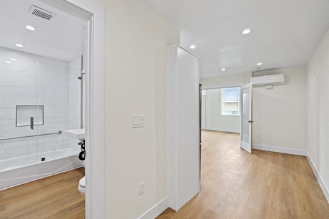 Unit with Vinyl Flooring and Hall Bathroom with Full-Size Bathtub