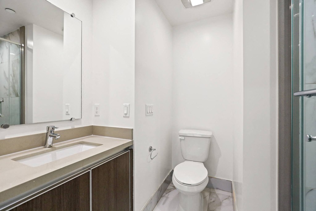 Bathroom with Walk-In Shower with Glass Door and Vanity Cabinet Storage