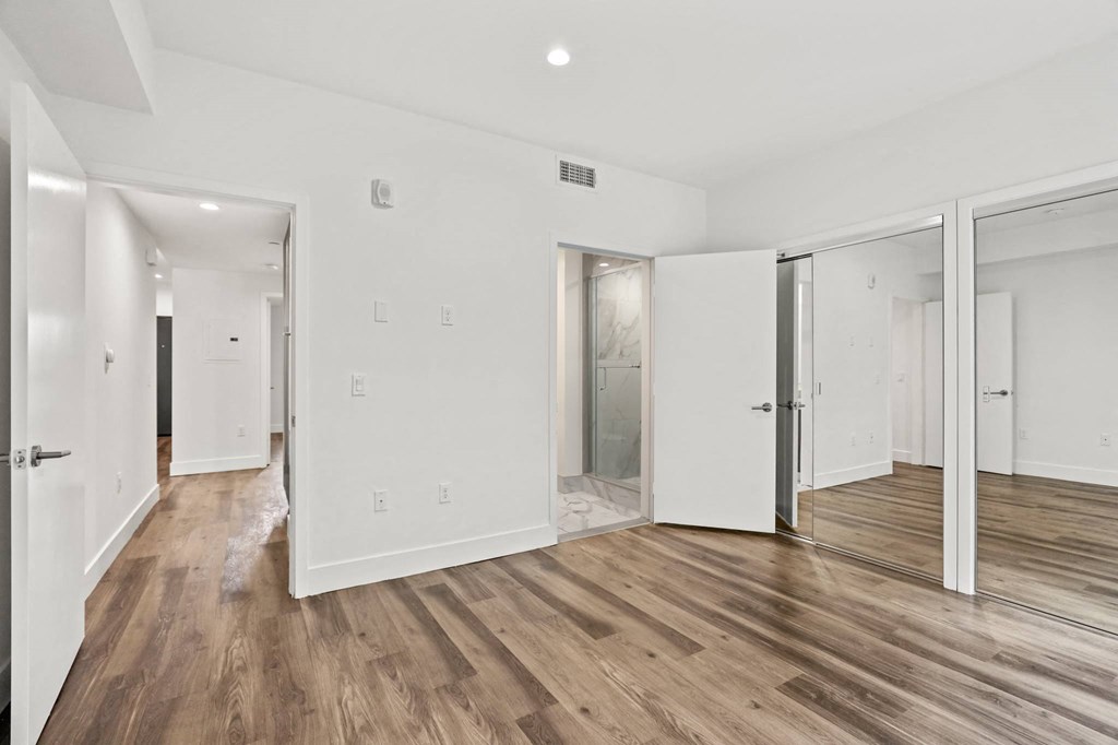 Bedroom with Bathroom and Double Mirrored Closets