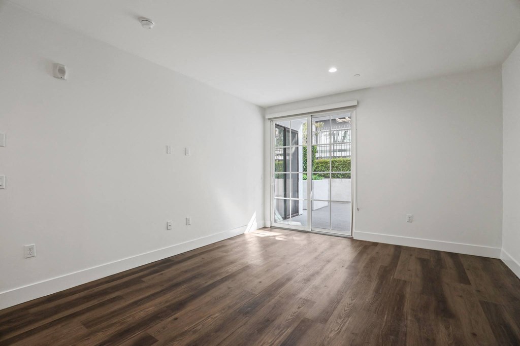 Spacious Bedroom with Patio, Vinyl Flooring, and Recessed Lighting