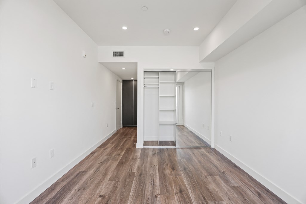 Bedroom with Closet with Built-In Shelving