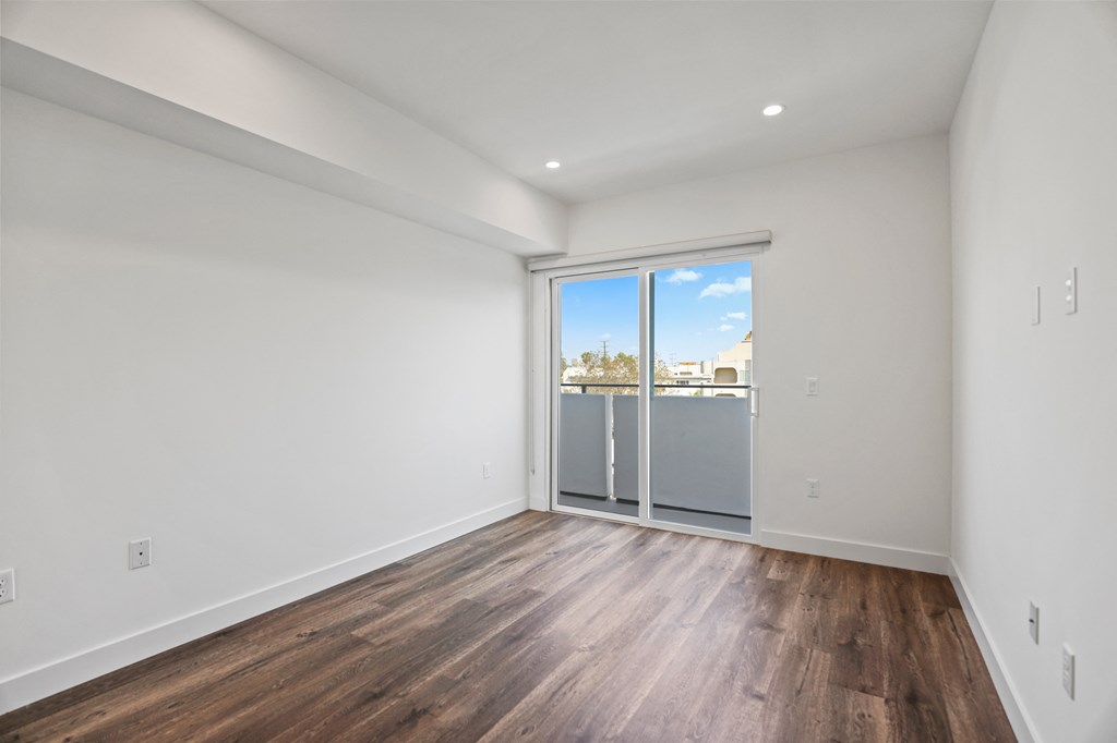 Bedroom with Recessed Lighting, Vinyl Flooring, and Balcony