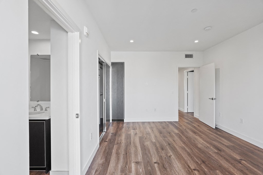 Bedroom with Closet, Vinyl Flooring, Recessed Lighting, and Bathroom