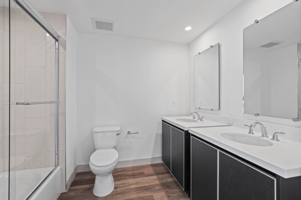 a bathroom with a toilet sink and shower