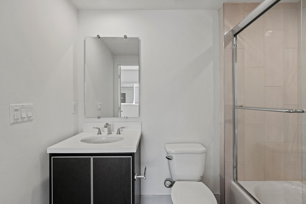 Bathroom with Shower Bath with Glass Door and Vanity Cabinet Storage