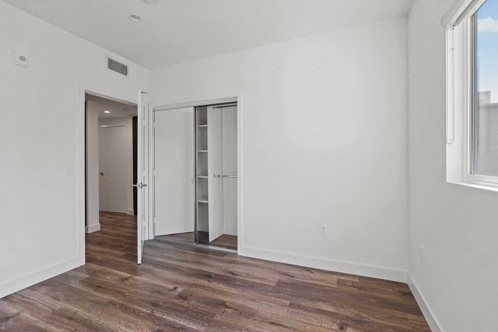 Bedroom with Vinyl Flooring, Recessed Lighting, Closet, and Window
