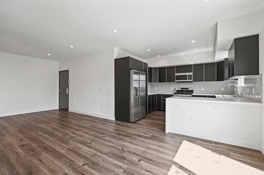 a kitchen and living room in an apartment