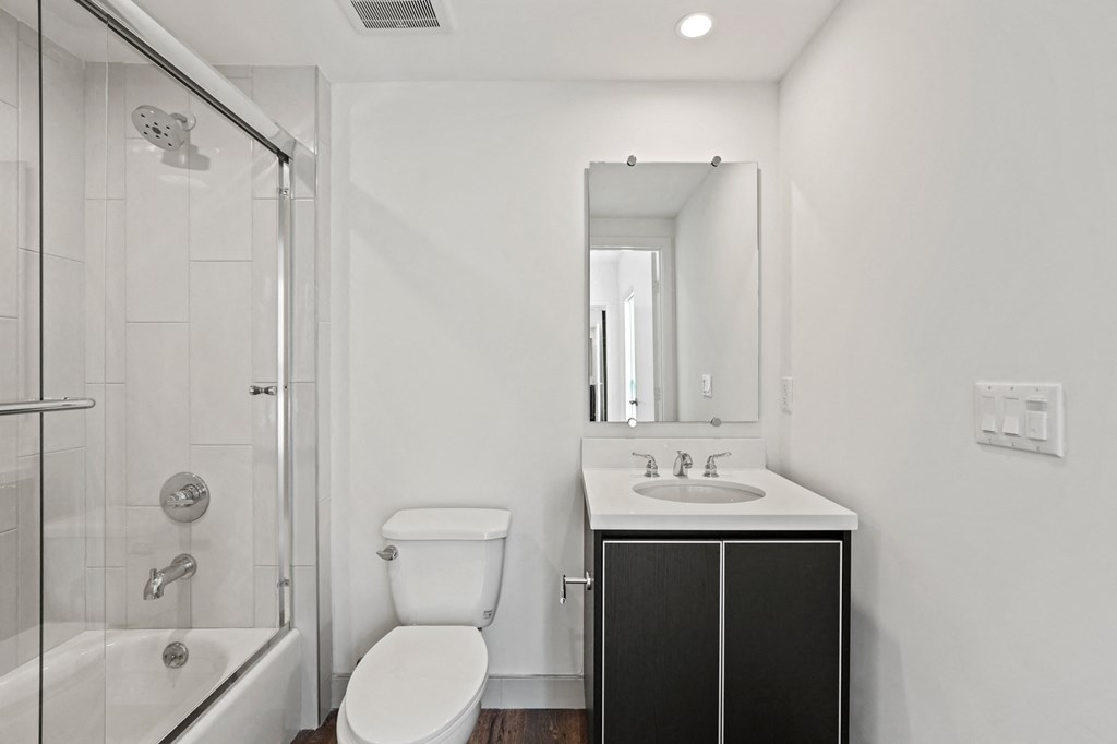 a bathroom with a toilet sink and shower