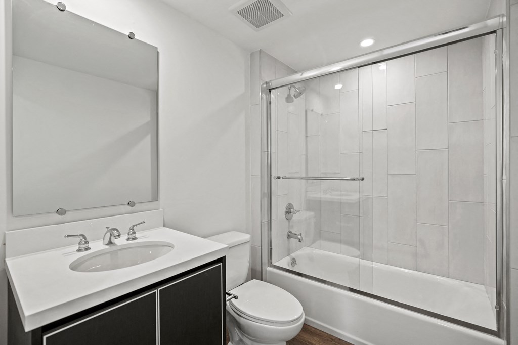 a bathroom with a sink toilet and shower