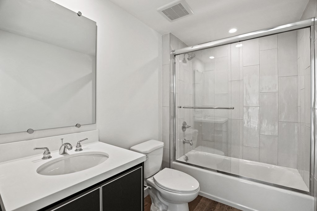 a bathroom with a sink toilet and shower