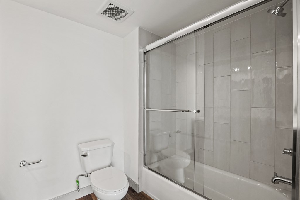 a bathroom with a toilet and a shower
