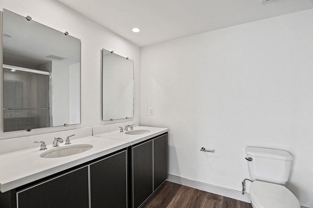 a bathroom with two sinks and a toilet