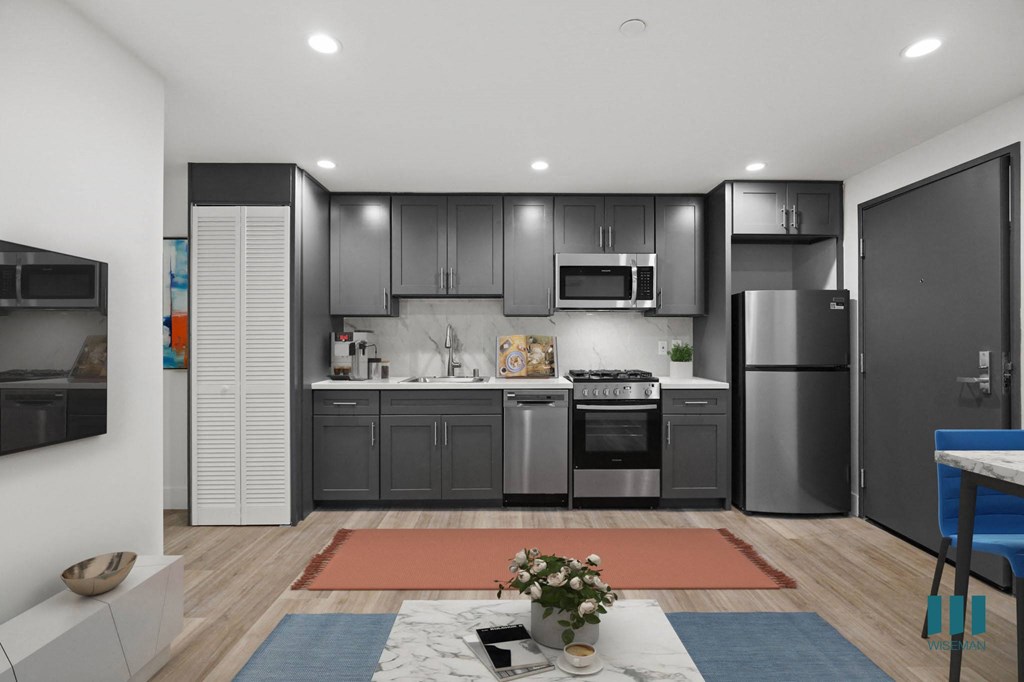 Open-Concept Kitchen with Stainless-Steel Appliances and In-Suite Washer & Dryer