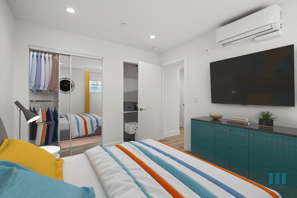 Bedroom with Mirrored Closet, Recessed Lighting, and Vinyl Flooring