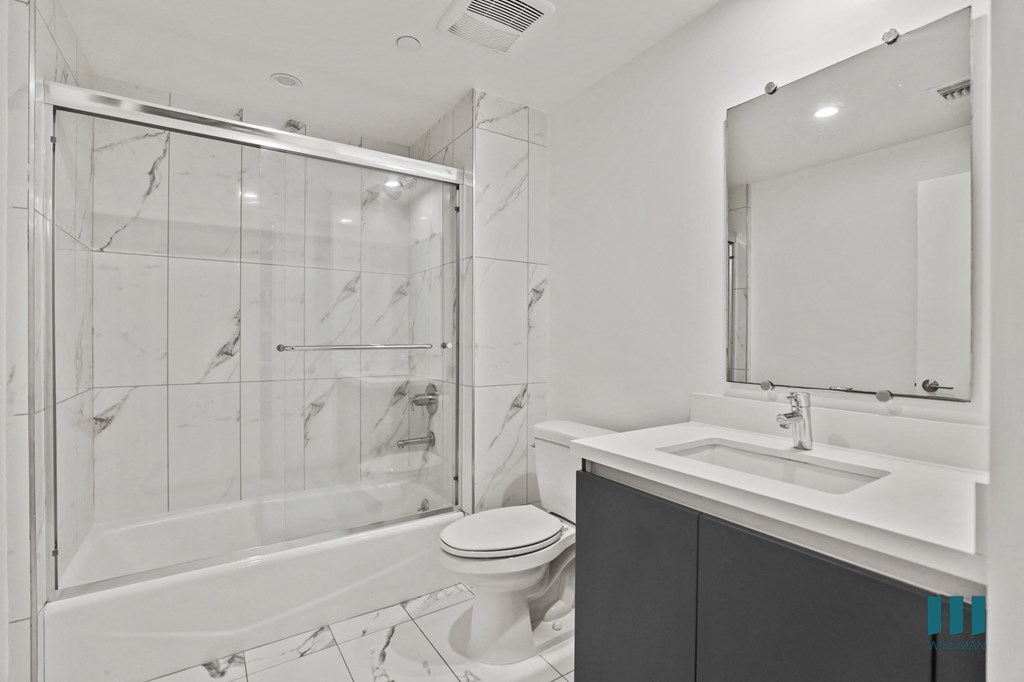 Bathroom with Shower Bath with Glass Doors and Vaniity Cabinet Storage