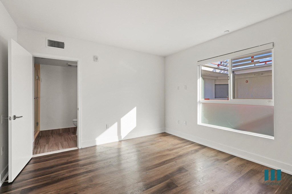 Bedroom with Bathroom, Vinyl Flooring, and Large-Size Windows