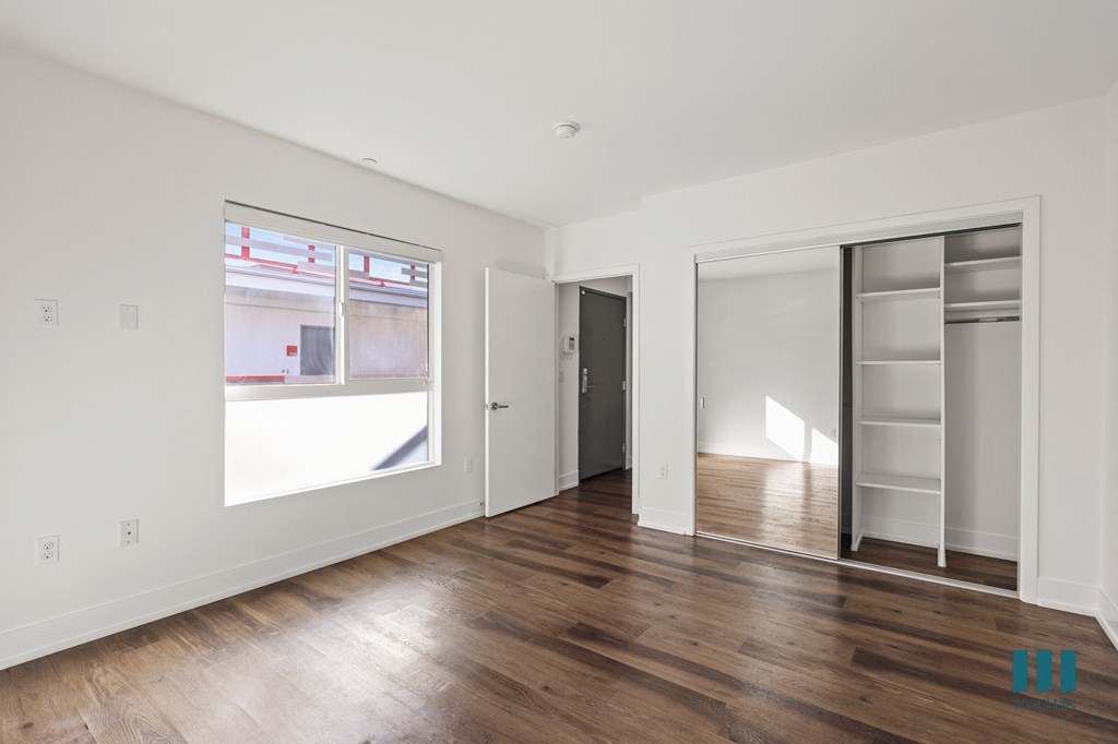 Bedroom with Recessed Lighting, Vinyl Flooring, Bathroom, Closet, and Large Windows