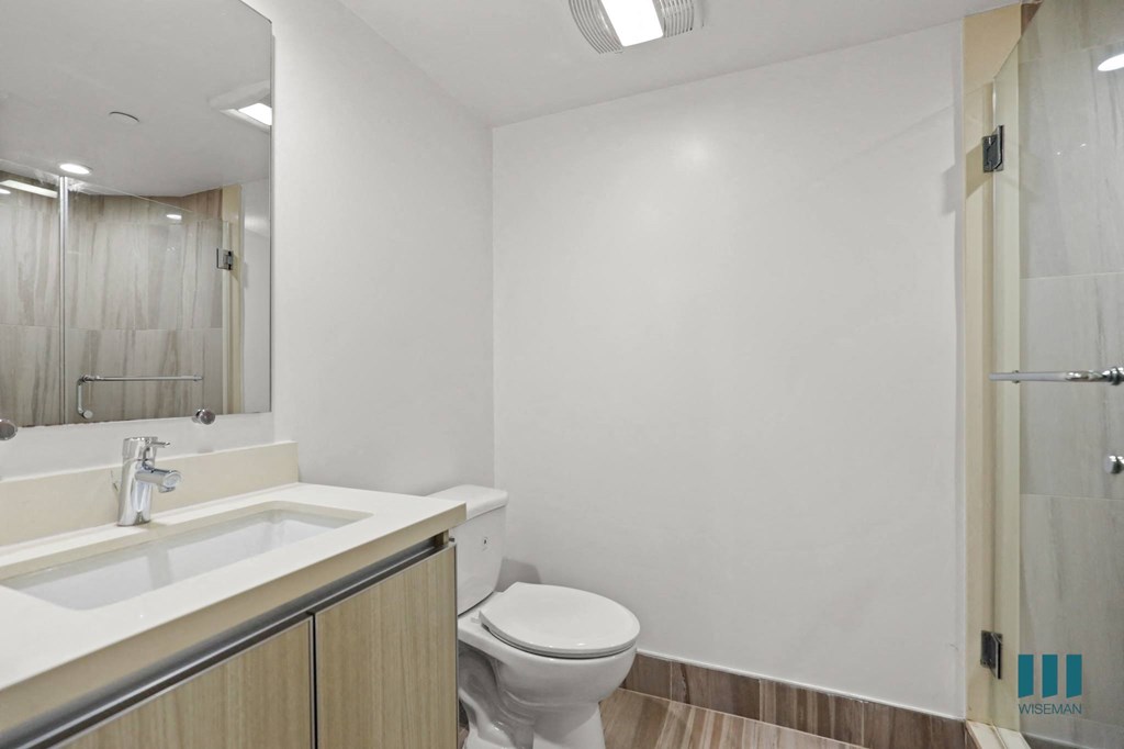 Bedroom with Stand-Up Shower and Vanity Cabinet Storage