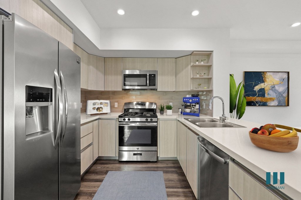 Open-Concept Kitchen with Countertop Bar, Energy-Efficient Appliances, and Ample Cabinet Storage