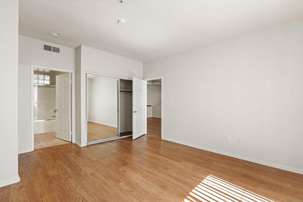Bedroom with Two Closets, Bathroom, and Vinyl Flooring